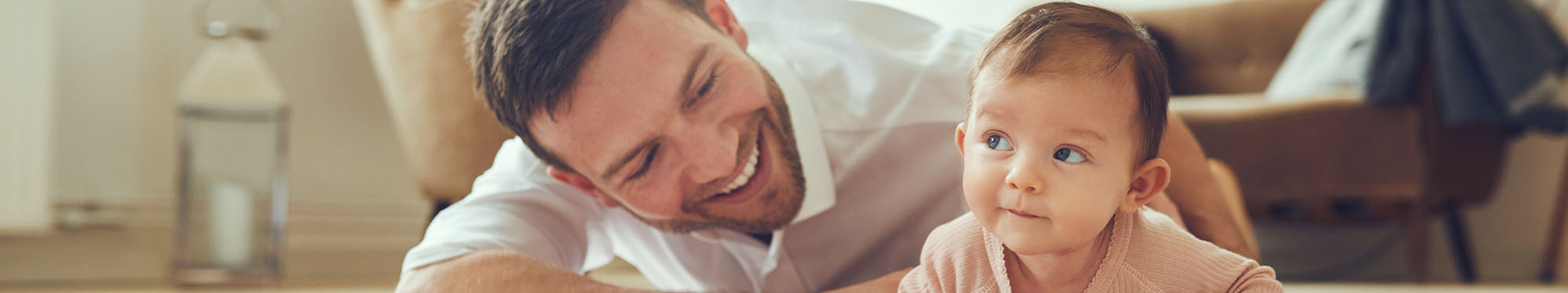 man smiling at a baby